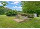 Inviting yard with wooden garden boxes, lush greenery, and natural landscape at 2815 Orange Grove Rd, Hillsborough, NC 27278