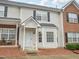 Charming townhouse featuring a covered entryway, bay window, and a mix of siding and brick facade at 2845 Bennington Dr, Clayton, NC 27520