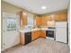 Well-lit kitchen featuring wood cabinets, white countertops and access to backyard at 2845 Bennington Dr, Clayton, NC 27520