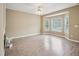 Bright living room with bay window, ceiling fan, and laminate flooring at 2845 Bennington Dr, Clayton, NC 27520