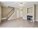 Open-concept living area with fireplace, staircase, and laminate floors at 2845 Bennington Dr, Clayton, NC 27520
