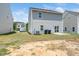 Backyard view of the two-story house with a patio and lawn at 304 Azalea Gaze Dr, Youngsville, NC 27596