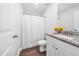 This bathroom is equipped with a granite countertop vanity, toilet and shower curtain at 304 Azalea Gaze Dr, Youngsville, NC 27596