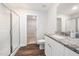 Bright bathroom with granite countertop vanity, glass enclosed shower, and open doorway to walk-in closet at 304 Azalea Gaze Dr, Youngsville, NC 27596