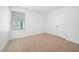 This carpeted bedroom features a window bringing in natural light and a double-door closet at 304 Azalea Gaze Dr, Youngsville, NC 27596
