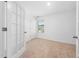 Empty bedroom with neutral carpet, natural light, and white trim at 304 Azalea Gaze Dr, Youngsville, NC 27596