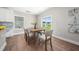 Bright dining room with wood floors, modern table set, and a sliding door to the backyard at 304 Azalea Gaze Dr, Youngsville, NC 27596