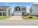 Charming two-story home with a large driveway, manicured lawn and stone and siding exterior at 304 Azalea Gaze Dr, Youngsville, NC 27596