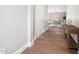 Inviting hallway with wood flooring that leads to a living room with neutral decor at 304 Azalea Gaze Dr, Youngsville, NC 27596