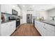 Spacious kitchen featuring stainless steel appliances, granite countertops, and bright white cabinetry at 304 Azalea Gaze Dr, Youngsville, NC 27596