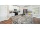 Well-lit kitchen featuring white cabinets, stainless steel appliances, and granite countertops at 304 Azalea Gaze Dr, Youngsville, NC 27596