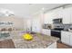 Large kitchen island with granite countertops and stainless steel sink, open to the living area at 304 Azalea Gaze Dr, Youngsville, NC 27596
