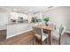 Modern kitchen with white cabinets, granite countertops, stainless steel appliances, and dining area at 304 Azalea Gaze Dr, Youngsville, NC 27596
