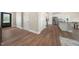 Bright, open-concept space highlighting the modern kitchen and adjacent living area with beautiful flooring at 304 Azalea Gaze Dr, Youngsville, NC 27596