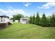 View of backyard with deck, storage shed, and privacy trees at 308 E Quailwood Dr, Fuquay Varina, NC 27526