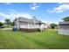 Lush green backyard with deck, gazebo, and detached storage shed at 308 E Quailwood Dr, Fuquay Varina, NC 27526