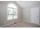 Bright bedroom with large window, neutral walls, and plush carpeting, offering a peaceful retreat at 308 E Quailwood Dr, Fuquay Varina, NC 27526