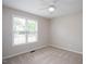 Neutral bedroom with carpet, ceiling fan, and natural light from large window at 308 E Quailwood Dr, Fuquay Varina, NC 27526