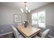 Well-lit dining room with a modern chandelier, table set for six, and natural light at 308 E Quailwood Dr, Fuquay Varina, NC 27526