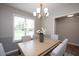 Bright dining room with natural light and stylish chandelier, perfect for Gathering gatherings and entertaining guests at 308 E Quailwood Dr, Fuquay Varina, NC 27526
