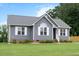 Well-kept home with grey siding, white trim, and a lush green lawn at 308 E Quailwood Dr, Fuquay Varina, NC 27526