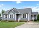 Charming single-story home with grey siding, white trim, and a well-manicured lawn at 308 E Quailwood Dr, Fuquay Varina, NC 27526