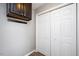 Neutral hallway features a dark storage cabinet above a coat rack and a large closet with white doors at 308 E Quailwood Dr, Fuquay Varina, NC 27526