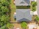 Aerial view of a home with a well-maintained roof and backyard with mature trees at 324 Farrow Glen Loop, Cary, NC 27519
