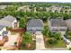 Aerial view showcasing a home with mature trees, a driveway, and a beautifully landscaped front yard at 324 Farrow Glen Loop, Cary, NC 27519