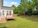 Manicured backyard with lush green grass and wooden deck at 324 Farrow Glen Loop, Cary, NC 27519