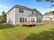 Spacious backyard featuring a large, well-maintained lawn and a wooden deck perfect for outdoor entertaining at 324 Farrow Glen Loop, Cary, NC 27519