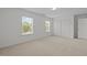Bedroom featuring neutral carpet, closet, windows, and a door to ensuite bathroom at 324 Farrow Glen Loop, Cary, NC 27519