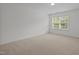 Spacious bedroom filled with light from a large window with views of the surrounding trees at 324 Farrow Glen Loop, Cary, NC 27519