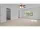 Bright bedroom with plush carpeting, closet, ceiling fan, and ample natural light at 324 Farrow Glen Loop, Cary, NC 27519