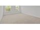 Bright bedroom with neutral carpet and natural light from two windows at 324 Farrow Glen Loop, Cary, NC 27519