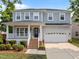 Charming two-story home featuring a welcoming front porch, attached two-car garage, and well-maintained landscaping at 324 Farrow Glen Loop, Cary, NC 27519