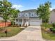 Attractive two-story home with an attached garage and a well-manicured lawn on a sunny day at 324 Farrow Glen Loop, Cary, NC 27519