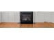 Living room fireplace with marble surround, hardwood flooring, and built-in cabinets at 324 Farrow Glen Loop, Cary, NC 27519