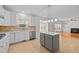 Spacious open kitchen with island, stainless steel appliances, and seamless connection to the living area at 324 Farrow Glen Loop, Cary, NC 27519