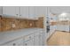 Bright kitchen with ample counter space, white cabinets, diamond backsplash, and modern appliances at 324 Farrow Glen Loop, Cary, NC 27519