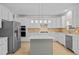 Modern kitchen with white cabinetry, stainless steel appliances, an island, and stylish pendant lighting at 324 Farrow Glen Loop, Cary, NC 27519