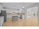 Spacious kitchen featuring white cabinets, stainless steel appliances, a center island, and tile flooring at 324 Farrow Glen Loop, Cary, NC 27519