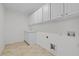 Laundry room with ample storage, tile floor, and washer/dryer hookups at 324 Farrow Glen Loop, Cary, NC 27519