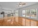 Open-concept living space with hardwood floors, connecting the kitchen to a sunroom and living area at 324 Farrow Glen Loop, Cary, NC 27519
