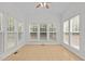 Sunroom with a vaulted ceiling and plentiful windows offering bright natural light and outdoor views at 324 Farrow Glen Loop, Cary, NC 27519