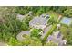 Sprawling estate featuring a swimming pool, tennis court, manicured lawns, and mature trees at 3347 Alamance Dr, Raleigh, NC 27609