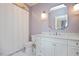 Well-lit bathroom featuring a vanity with marble countertop, shower with curtain, and updated fixtures at 3347 Alamance Dr, Raleigh, NC 27609