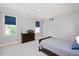 Cozy bedroom featuring a ceiling fan, blue window treatments, gray walls and a gray bedspread at 3347 Alamance Dr, Raleigh, NC 27609