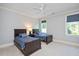 Bright bedroom with neutral carpet, featuring two twin beds with dark wood trim and blue bedding at 3347 Alamance Dr, Raleigh, NC 27609