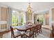 Bright dining room featuring a chandelier, large windows, and elegant decor at 3347 Alamance Dr, Raleigh, NC 27609